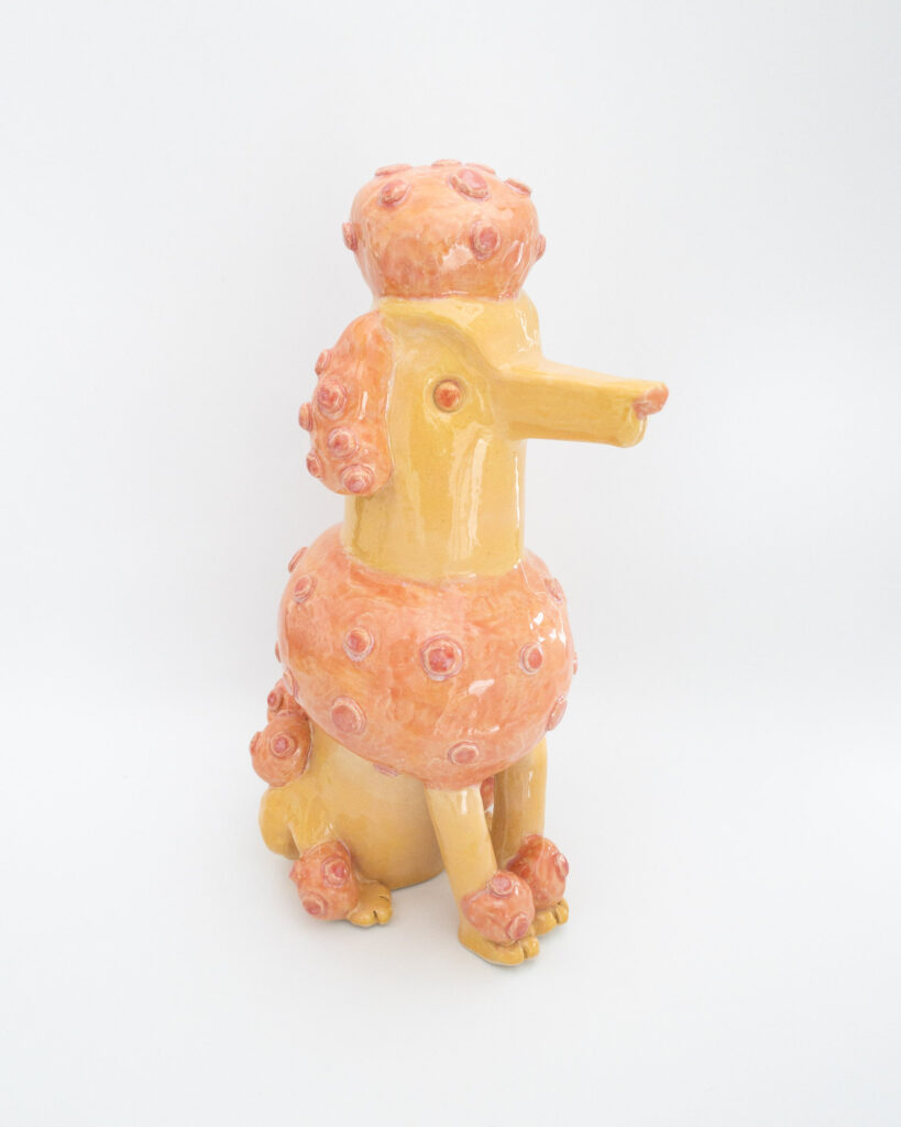 Ceramic poodle in pink and orange glazes