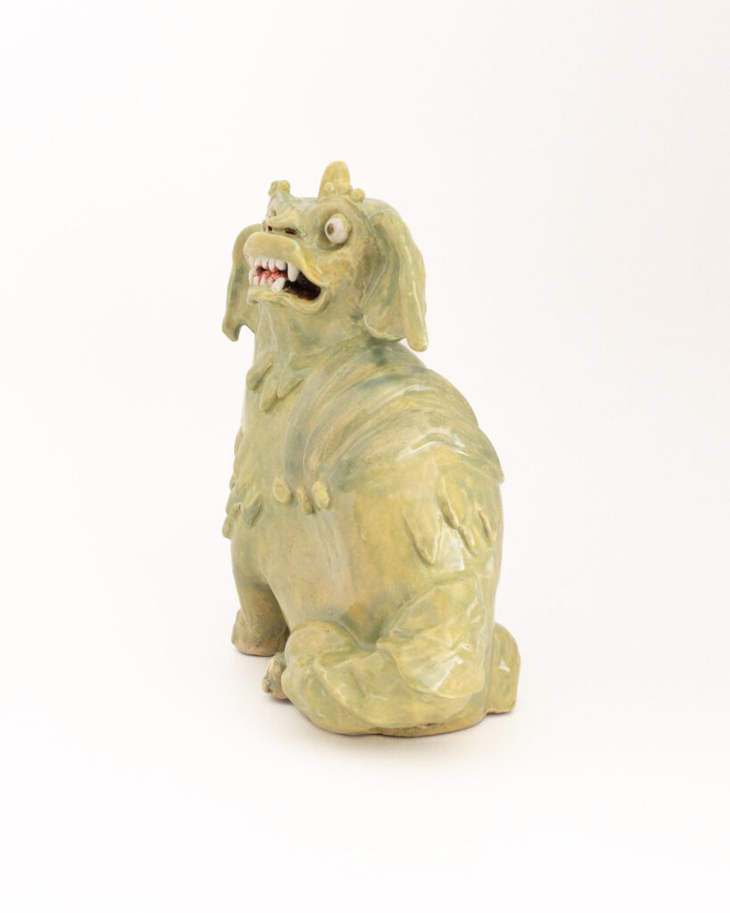 Ceramic sculpture based on Chinese-style dogs or lions in the Brighton pavilion, with green glaze, side view