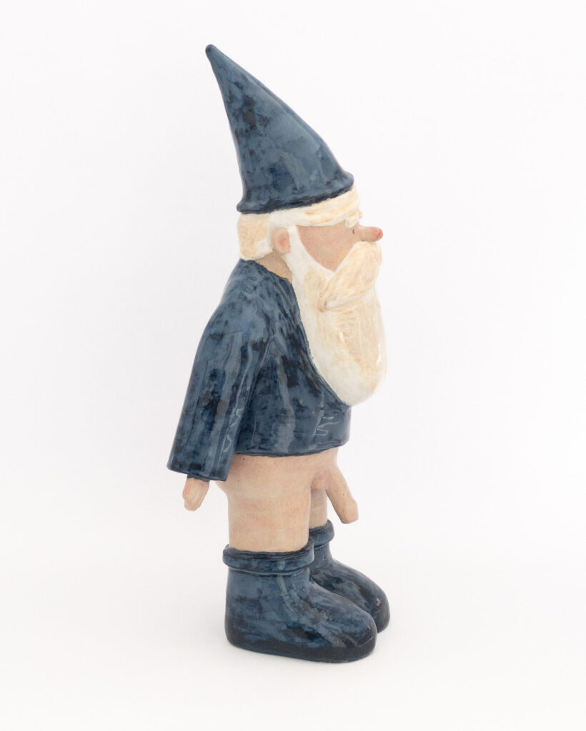 Ceramic gnome wearing blue hat, shirt and boots, but no trousers, side view