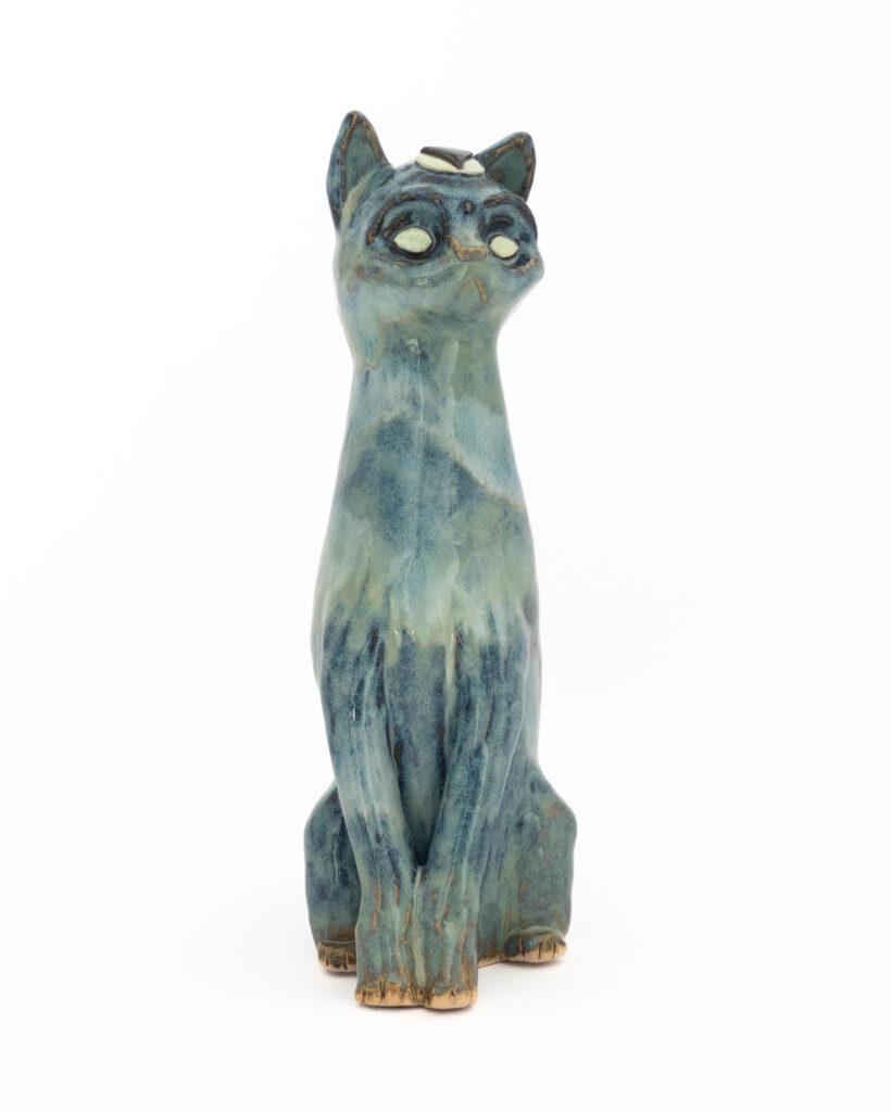 Ceramic sculpture of a cat representing water, with cloudy drippy glazes in blues and greens