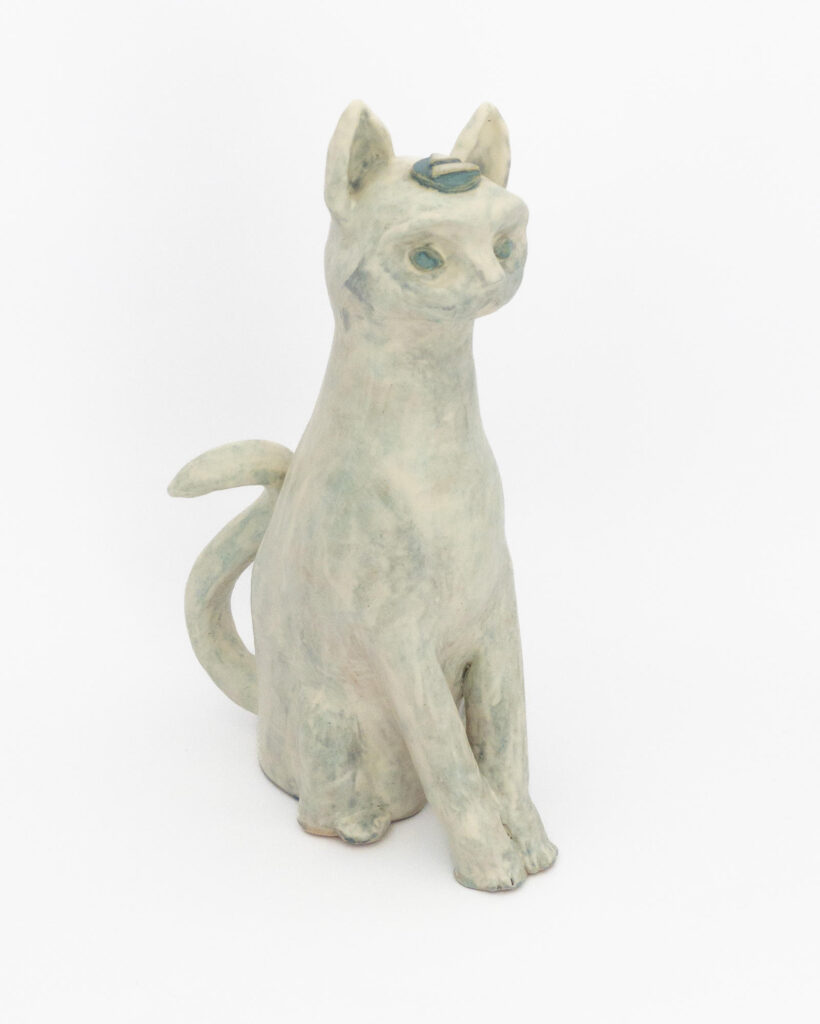 Ceramic sculpture of a cat representing air, in matte white glaze with hints of light blue