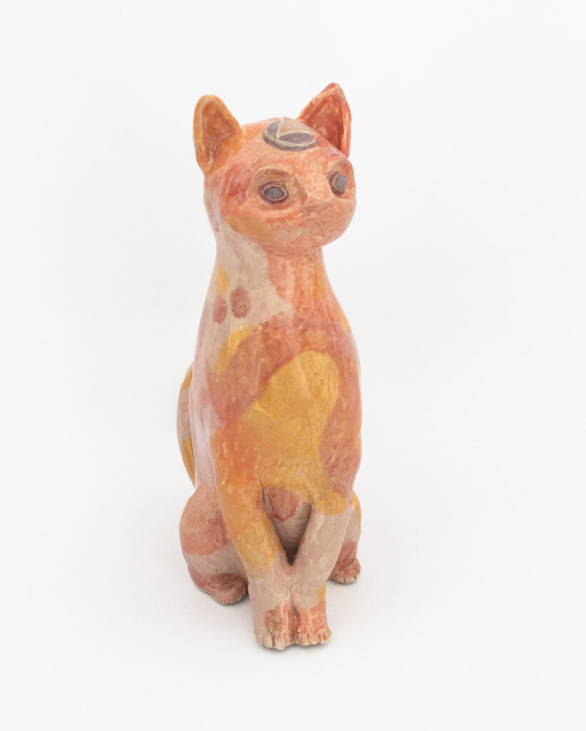 Ceramic sculpture of a cat representing fire, with swirls of pink and orange glazes