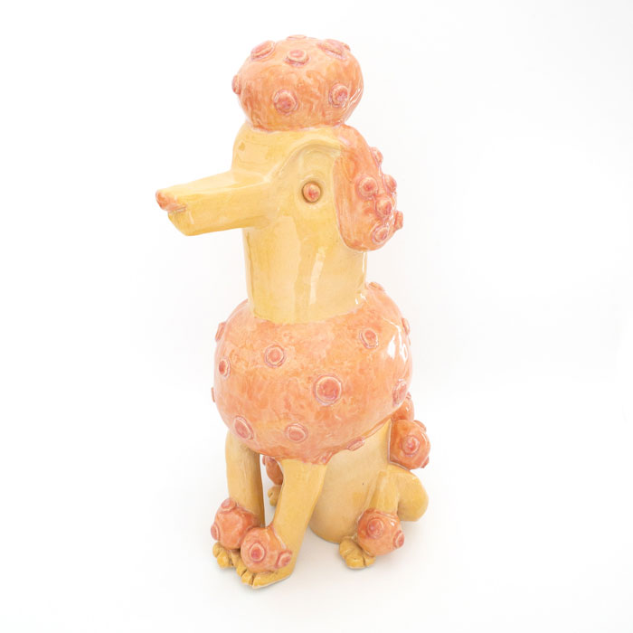 Ceramic sculpture of a whimsical poodle with pink and orange glaze
