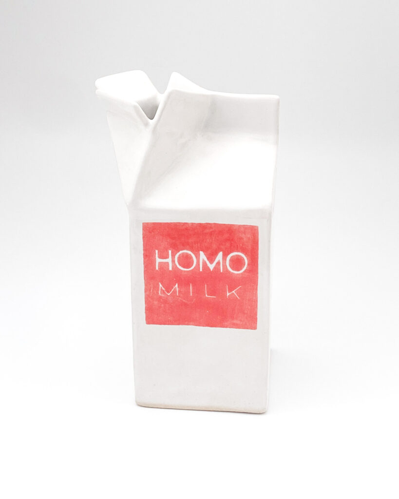 Ceramic milk carton which reads Fresh 100% on two sides and Homo Milk on the other two