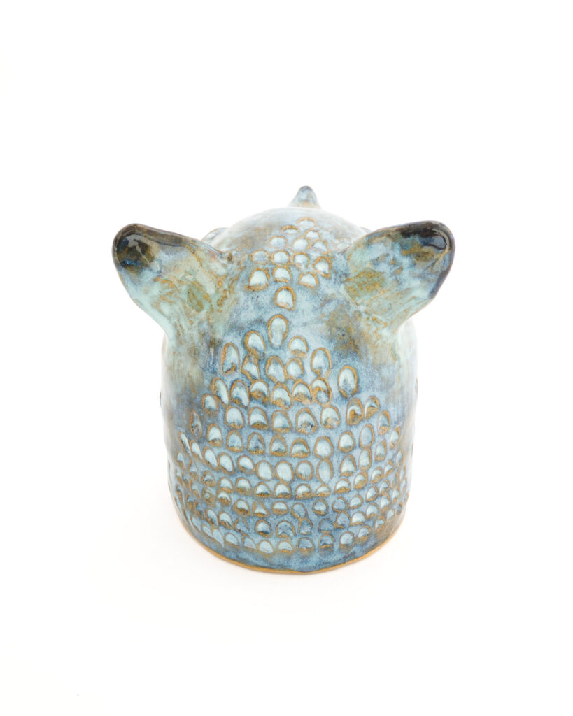 Fox head in textured blue and brown glazes, from behind