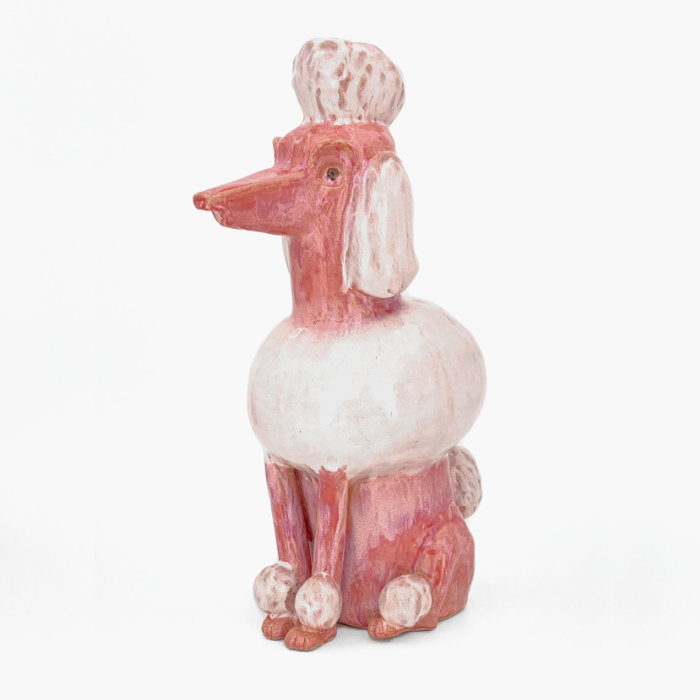 Ceramic sculpture of a poodle in a textured pink glaze