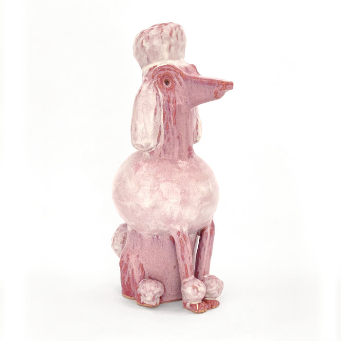 Ceramic sculpture of a poodle in a melty purple glaze