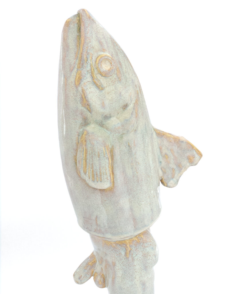 Reverse merman with fish head and man's legs, in an iridescent pearly glaze, close up of the head