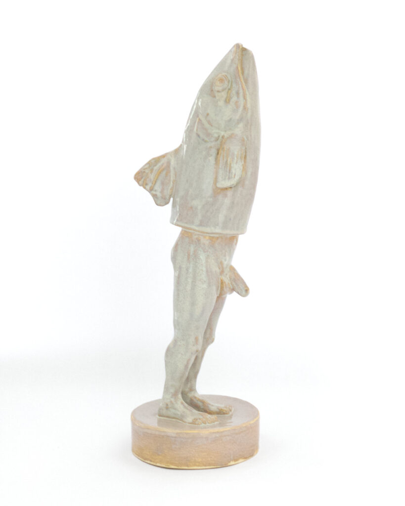 Reverse merman with fish head and man's legs, in an iridescent pearly glaze