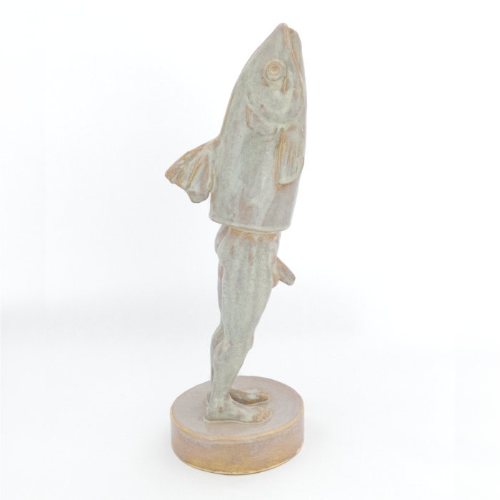 Ceramic sculpture of a reverse merman with a fish head and a man's legs, in a pearlescent glaze