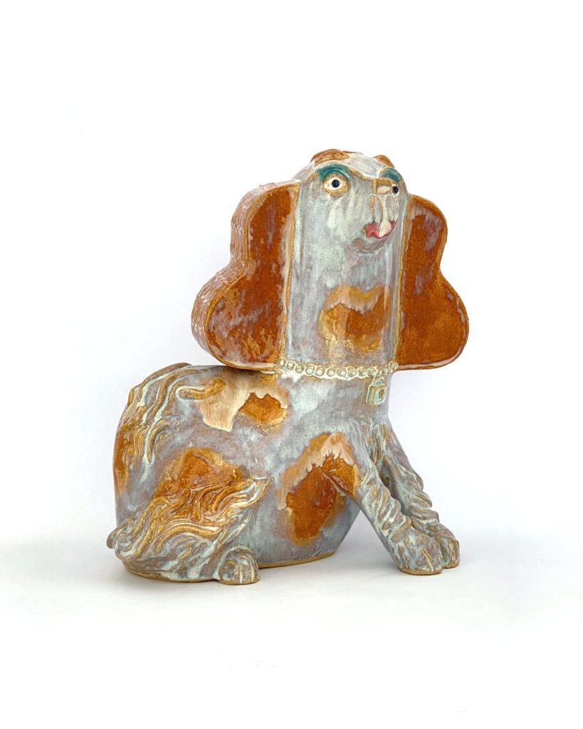 Ceramic spaniel in brown and white melty glazes, with eyeshadow and lipstick